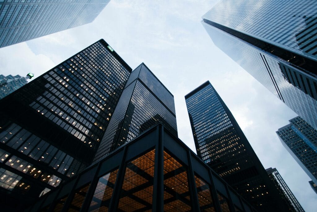 View of city skyscrapers, looking up from pavement level.
