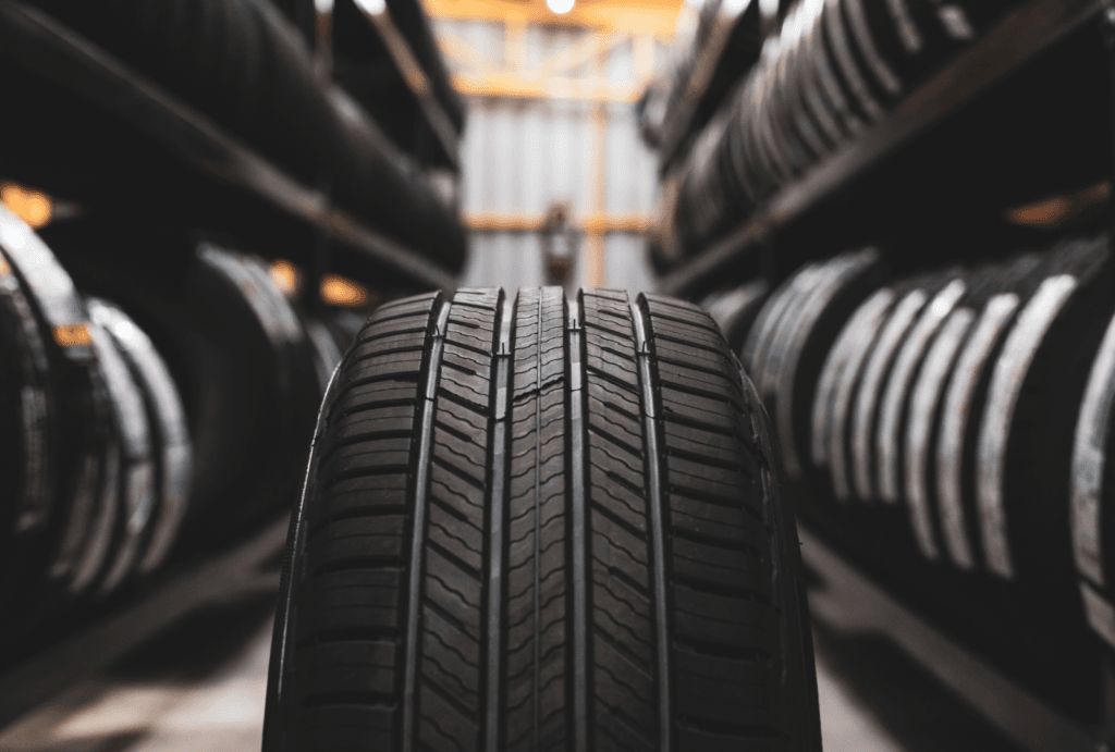 black rubber tyres stacked on shelves in a workshop